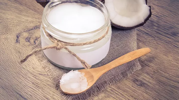 Coconut oil on a spoon for oil pulling